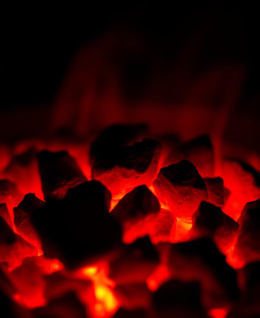 Glowing red coals in a table-top grill